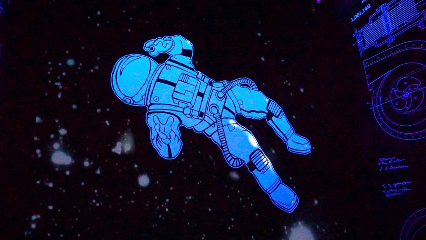 En tecknad blå astronaut som svävar i yttre rymden.